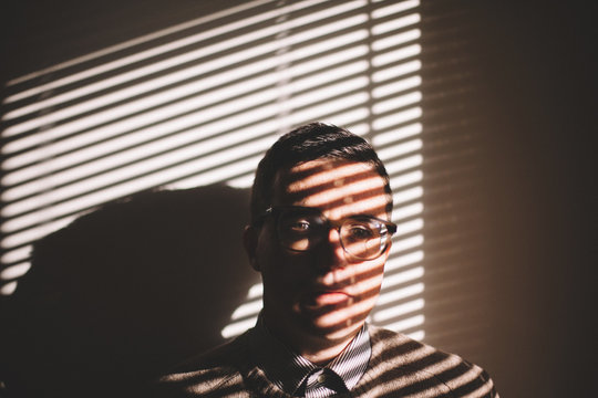 Elegant Man With Glasses Close to a Window . Portrait