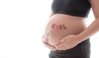 Belly of a pregnant woman with the word " GIRL " isolated on white background