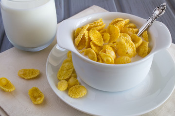 Healthy breakfast with corn flakes and milk in the white plate 