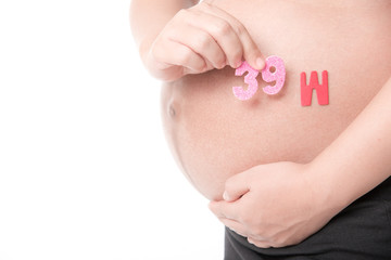 Belly of a pregnant woman with the word " 39 week " isolated on white background