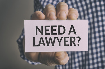 Need a lawyer? card in hand. Legal support and justice concept.