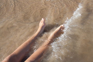 feet which are washed by sea water on the sand