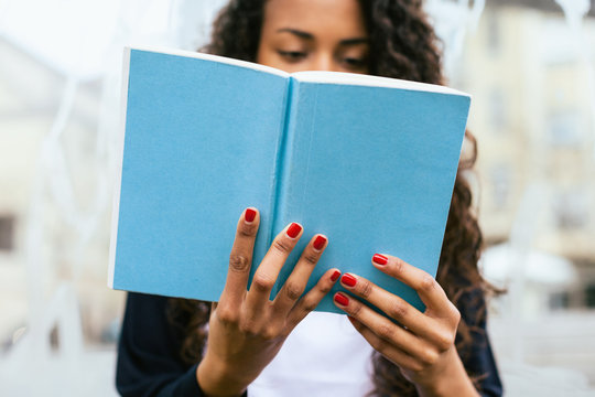 Close-up of woman reading a book