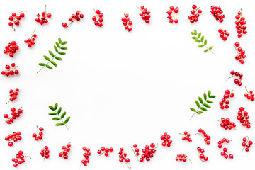 Berry frame. Red currant and leaves on white background top view copyspace