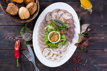  Meat plate on a wooden background on top