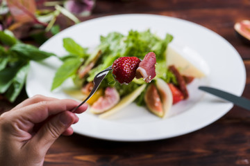 Bacon and strawberries on a plate background