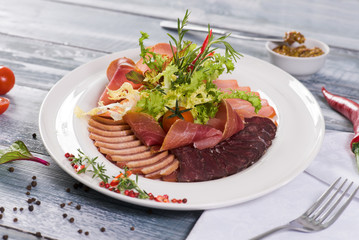  Meat plate on a gray wooden background