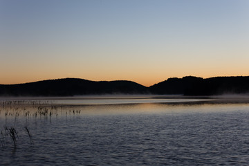 Mist at sunrise on Lake Ilay, in the French Jura