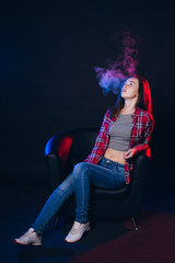 Fototapeta premium Woman smoking electronic cigarette with smoke