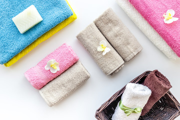 Preparing to take bath. Towels and soap on white background top view