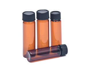 Brown travel medicine vials with caps isolated on white background