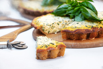 Homemade cake with short bark beetroot with tofu and spinach decorated with basil leaves. on a white background