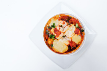 Baked vegetables zucchini and tomatoes with cheese. Isolated on white by clipping path.