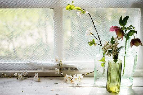 Antique Glass Apothecary Bottles With Spring Flowers.