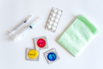 Visit the urologist. Syringes, pills and condoms on white background top view