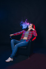 Obraz na płótnie Canvas Woman smoking electronic cigarette with smoke