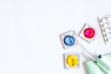 Visit the urologist. Syringes, pills and condoms on white background top view copyspace