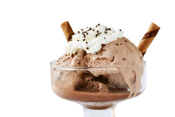 Melting chocolate ice cream with whipped cream and wafer rolls