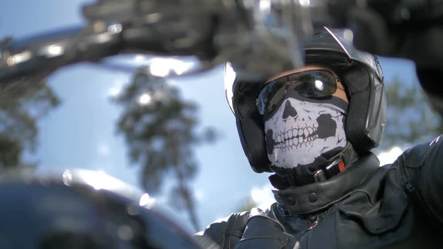 A bikers portrait. Head covered by a helmet and a mask.