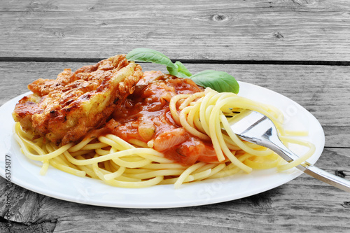 &amp;quot;Schnitzel with spaghetti, tomato sauce and basil on wooden table ...