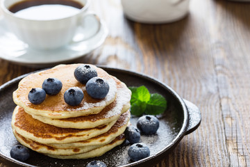 Blueberry buttermilk pancakes on rustic table
