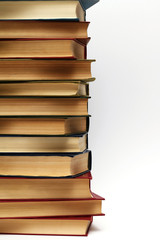 stack of different old books on a white background