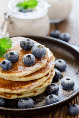 Healthy organic blueberry smoothie in glass jar and buttermilk pancakes