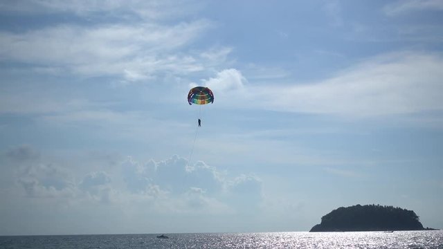 4k video of traveler parasailing with speed boat over the sea