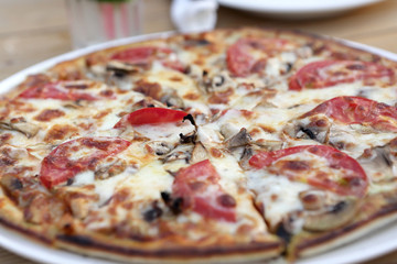 Pizza with mushrooms in cafe