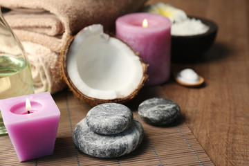Beautiful spa composition with coconut and candles on table
