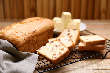 Cooling rack with delicious butter cake on wooden table