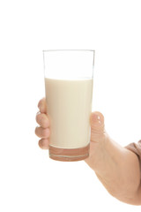 Old woman holding glass with fresh milk on white background