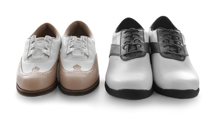 Two pairs of leather golf shoes on white background