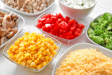 Ingredients for cooking turkey casserole on white wooden background