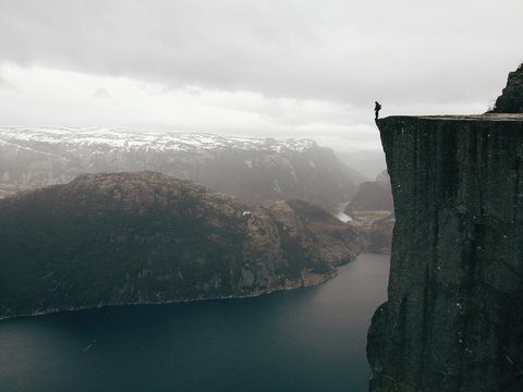 A hiker on the edge at Preikestolen in Norway (mobile version)