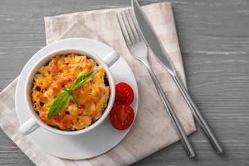 Ceramic pot with turkey casserole on wooden table