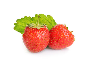Ripe strawberries and leaf on white background