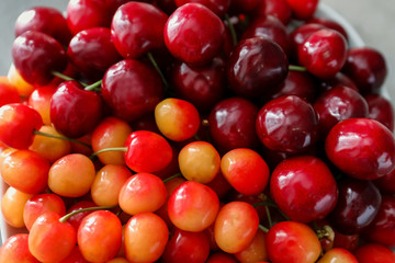 Plate with fresh ripe cherries, close up
