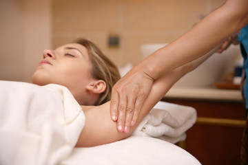 Fototapeta na wymiar Young woman having massage in spa salon, closeup view