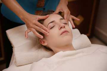 Obraz na płótnie Canvas Young woman having massage in spa salon, closeup view