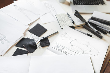 Fashion Sketches and Textiles Equipment on a Desk