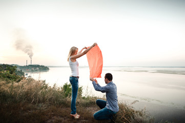 Man and woman launch a heart shaped flashlight in the sky