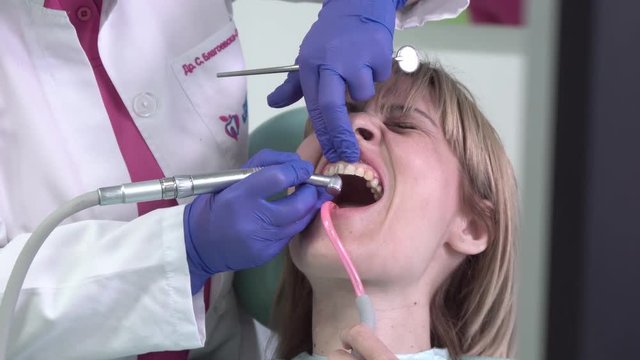 Woman at the dentist clinic office gets dental medical examination and treatment