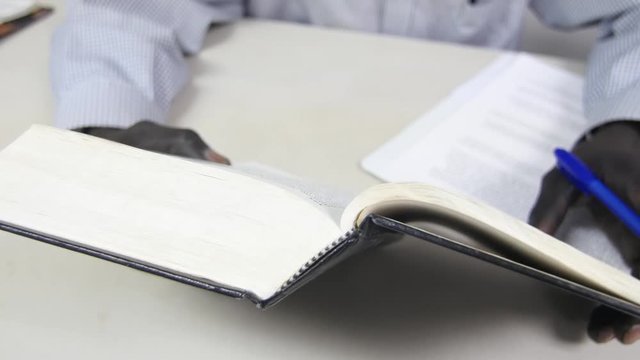 A man takes notes at as he studies the Bible.
