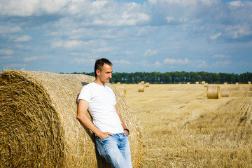 Naklejka na ściany i meble young businessman on yellow wheat field