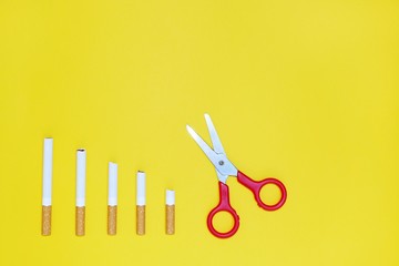 Quit smoking concept, cigarettes on yellow background