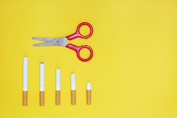 Quit smoking concept, cigarettes on yellow background