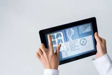 Close of female doctor hands working with tablet pc computer