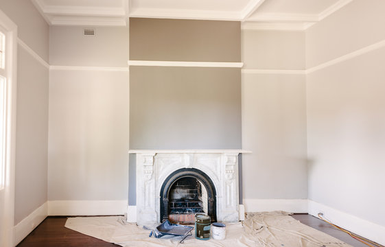 renovation project: painting rooms featuring a fireplace and picture rail