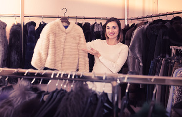 Girl choosing mink jacket